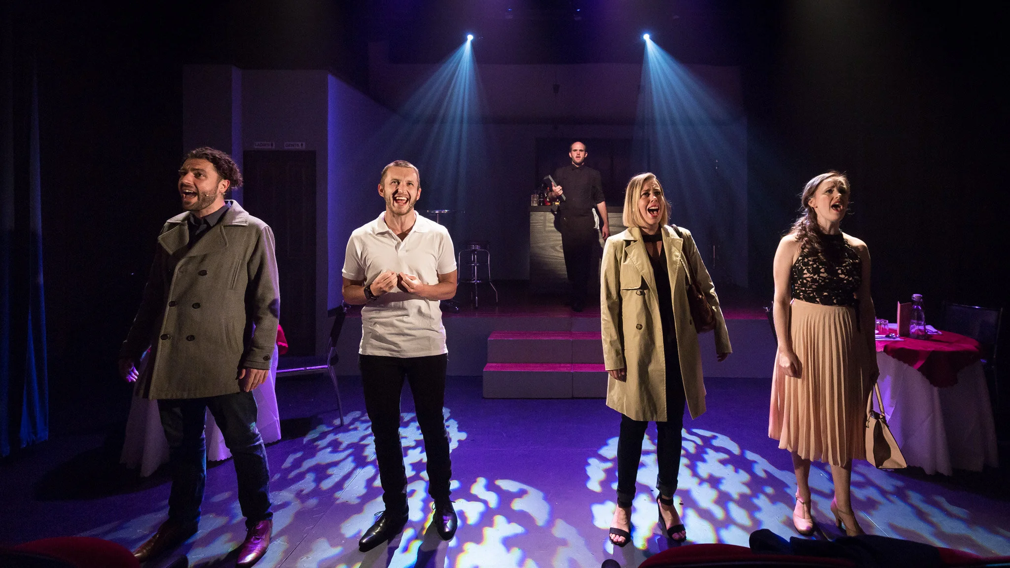 First Date ensemble spread across the stage beneath blue and purple lighting.